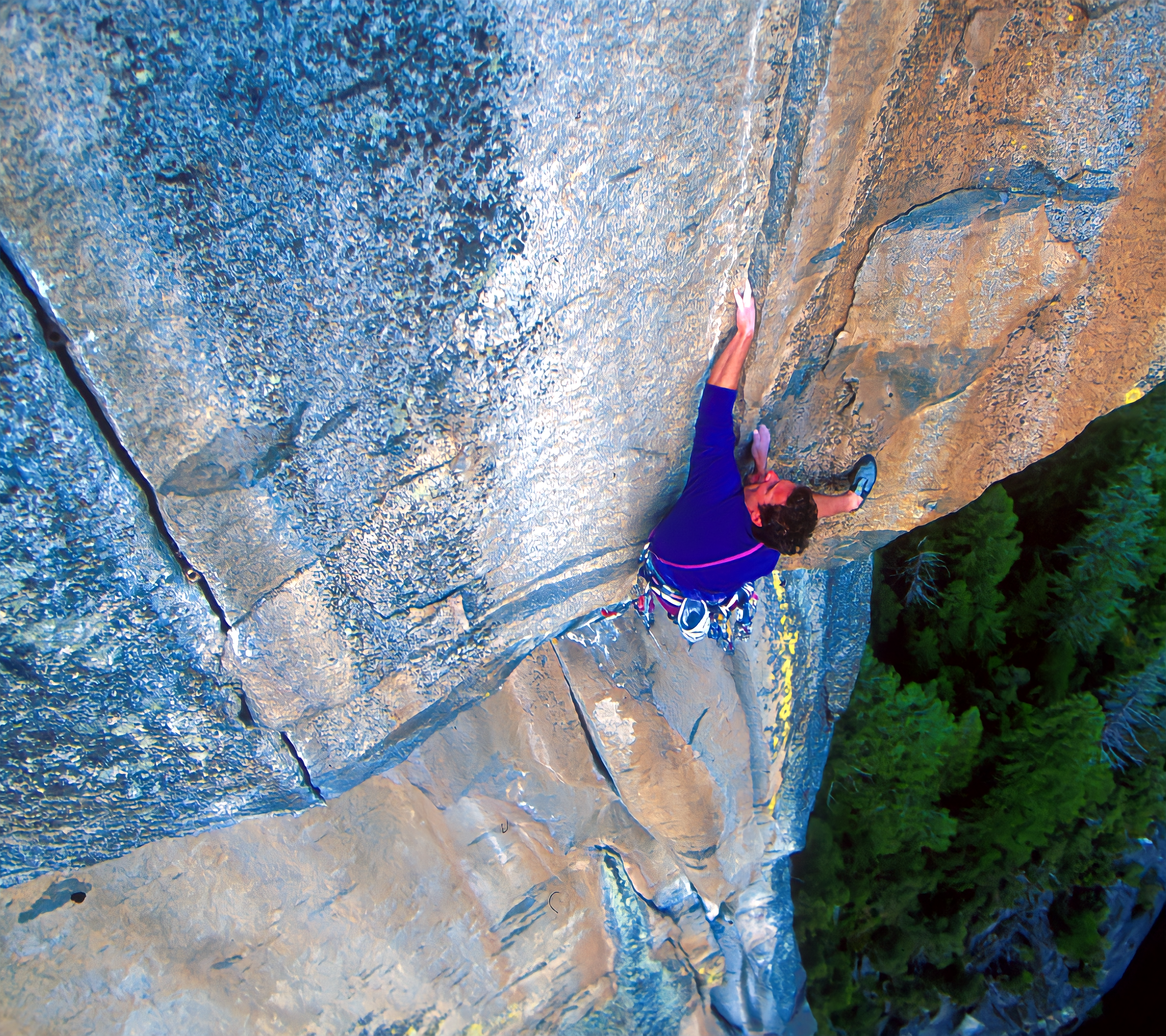 Dr. Russ mcBride climbing the face of a cliff.